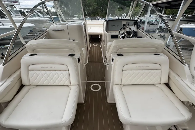 Slide: The Image of 2023 Grady-White Freedom 285 boat interior with luxurious seating and modern dashboard. - 4