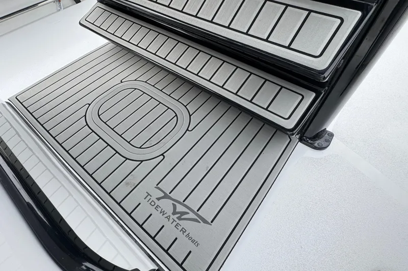 Slide: The Image of 2026 Tidewater 302 CC Adventure boat deck with sleek, modern design and logo detailing. - 11