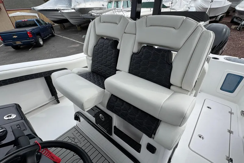Slide: The Image of Luxury seating on 2026 Tidewater 302 CC Adventure boat, featuring sleek design and premium materials. - 12