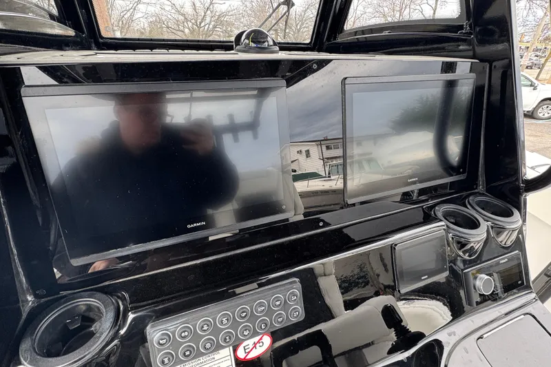 Slide: The Image of Helm of 2026 Tidewater 302 CC Adventure with dual Garmin displays and control panel. - 13