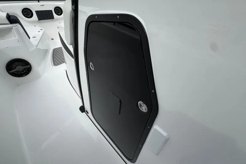 Slide: The Image of 2026 Tidewater 302 CC Adventure boat interior with black hatch door and speakers. - 18