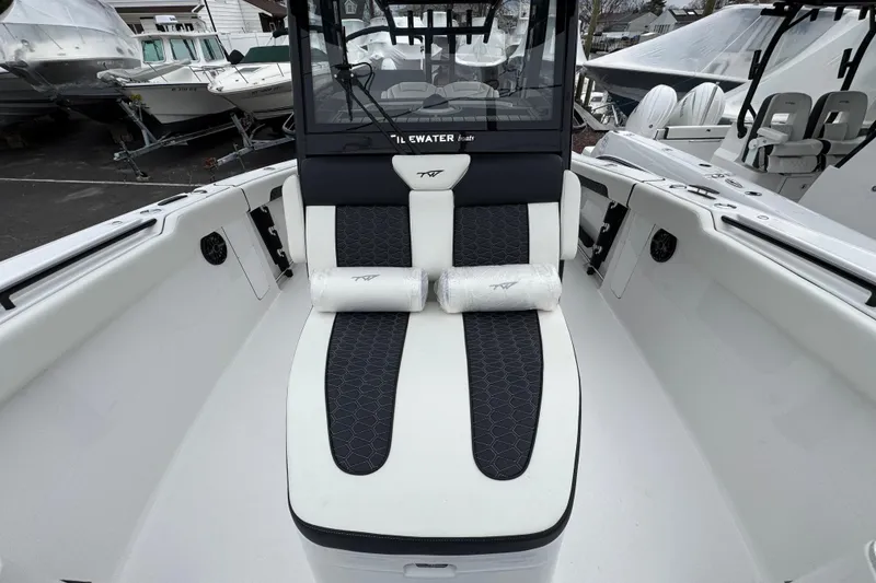 Slide: The Image of 2026 Tidewater 302 CC Adventure boat interior with cushioned seating and sleek design. - 21