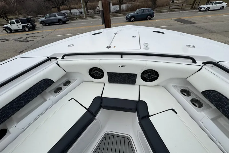 Slide: The Image of 2026 Tidewater 302 CC Adventure boat interior with seating, cup holders, and speakers. - 24