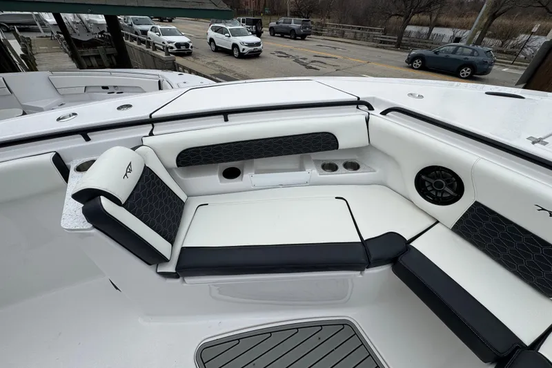 Slide: The Image of 2026 Tidewater 302 CC Adventure boat interior with cushioned seating and cup holders. - 25