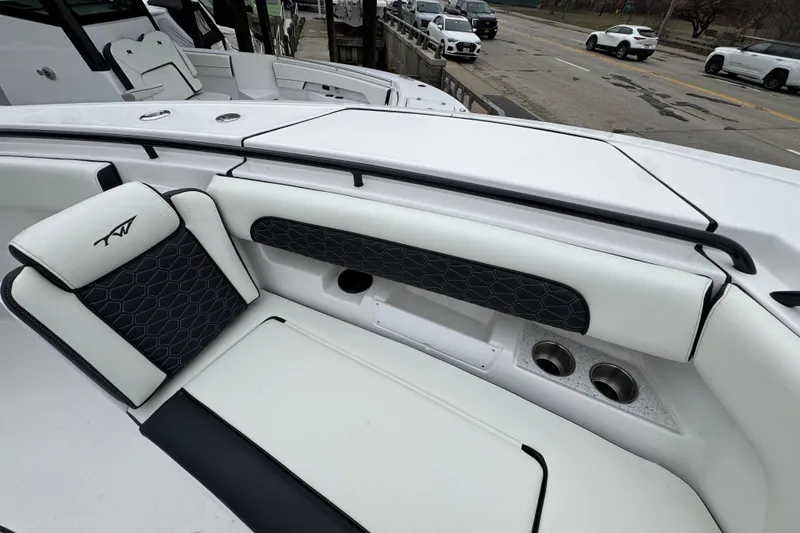 Slide: The Image of 2026 Tidewater 302 CC Adventure boat interior with sleek seating and cup holders. - 27