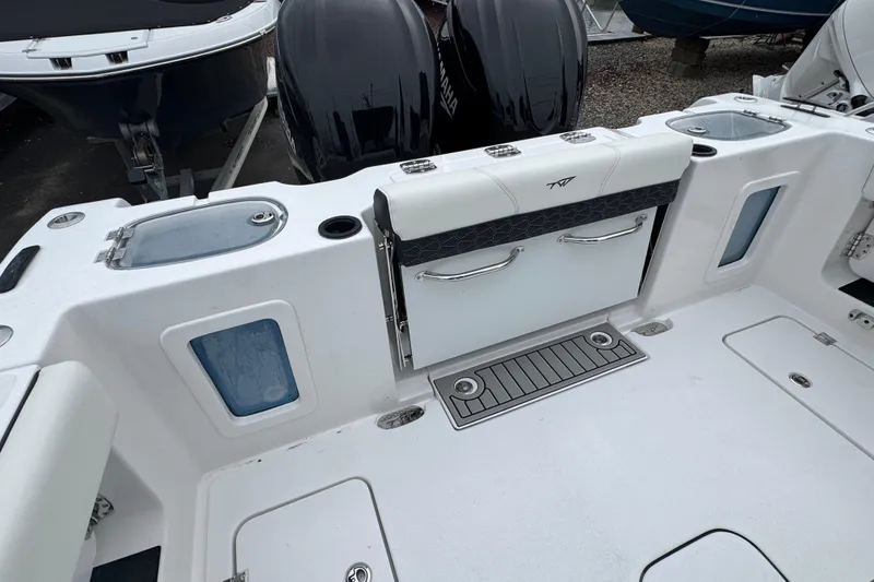 Slide: The Image of 2026 Tidewater 302 CC Adventure boat deck with storage and seating features. - 3