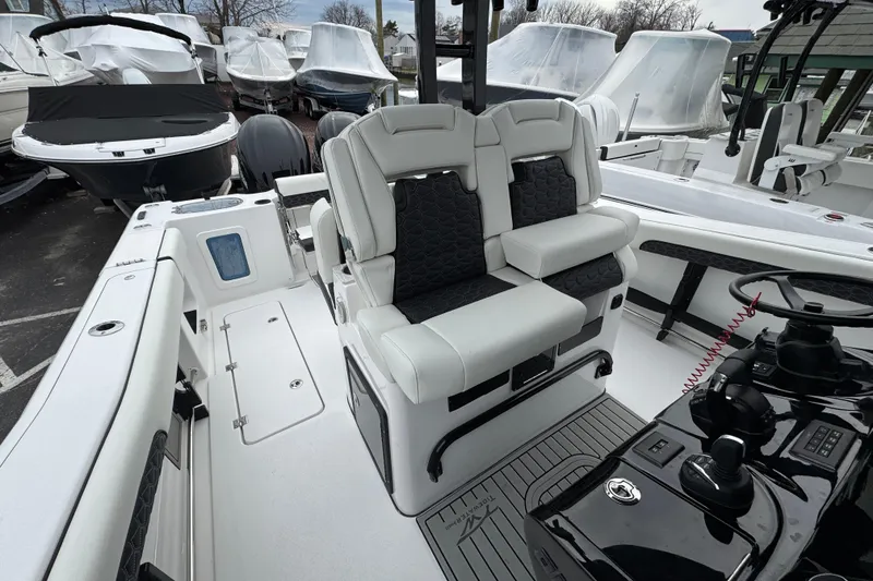 Slide: The Image of 2026 Tidewater 302 CC Adventure boat interior with dual seating and modern console. - 30