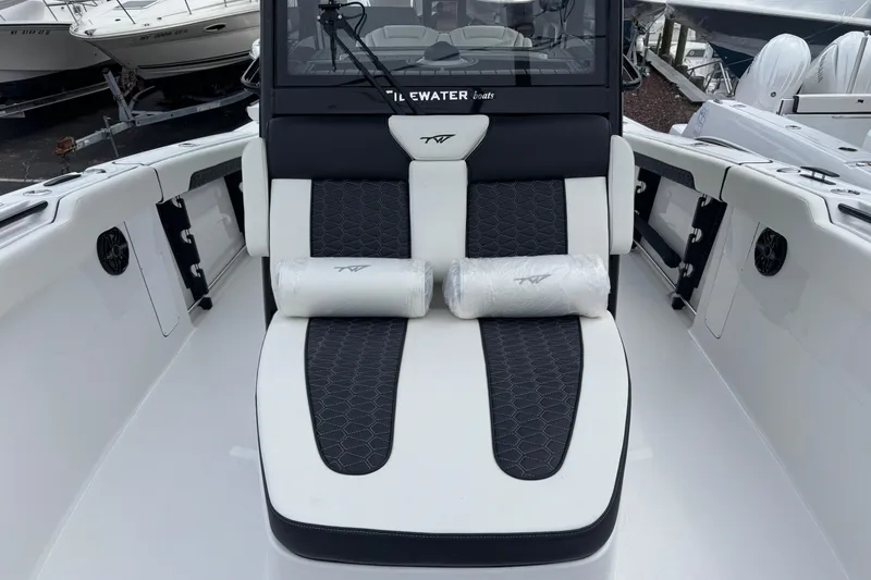 Slide: The Image of 2026 Tidewater 302 CC Adventure boat interior with cushioned seating and modern design. - 31