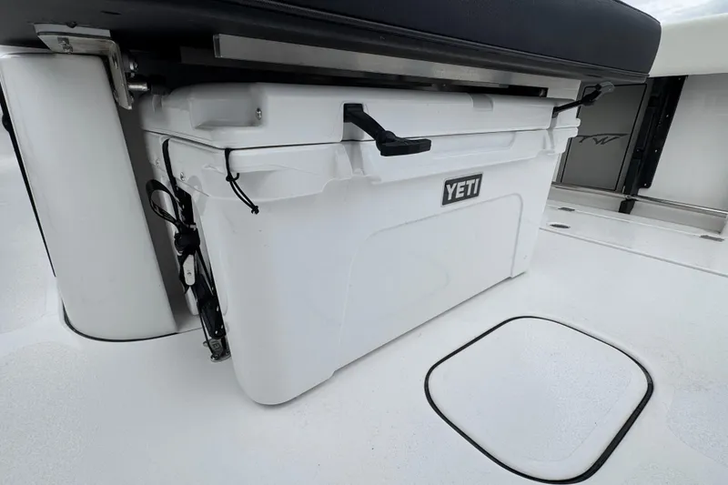 Slide: The Image of YETI cooler on 2026 Tidewater 302 CC Adventure boat deck, under seat storage. - 6