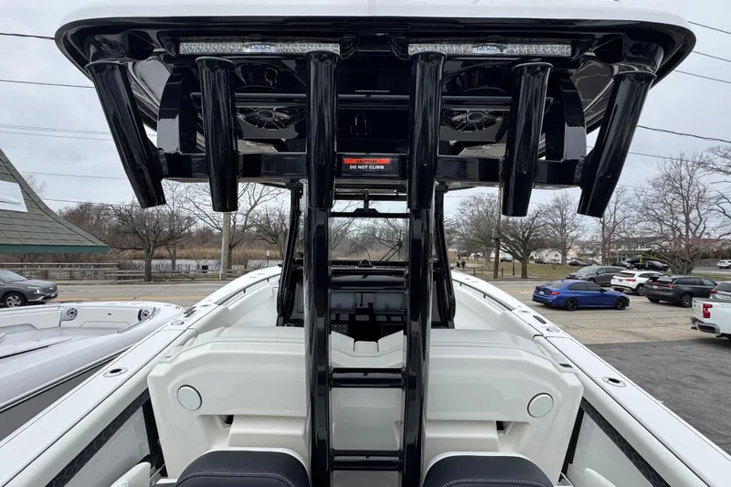 Slide: The Image of 2026 Tidewater 302 CC Adventure boat interior with sleek black T-top and seating. - 7