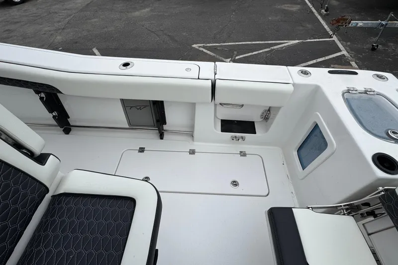 Slide: The Image of 2026 Tidewater 302 CC Adventure boat interior with seating and storage compartments. - 9