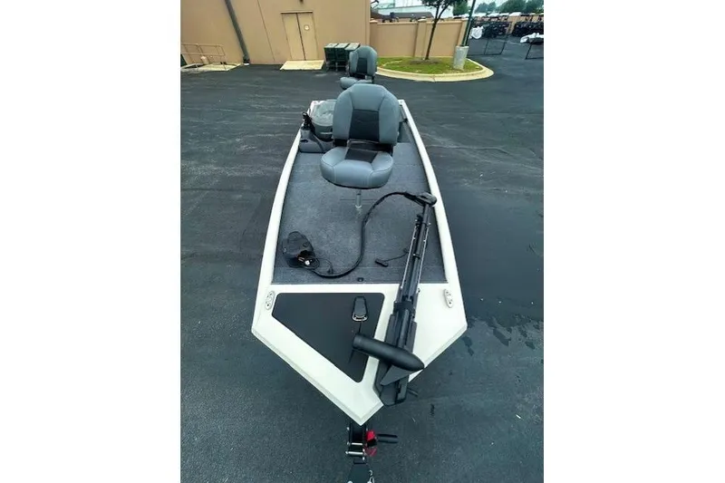 Slide: The Image of 2026 Tracker Pro 170 boat with seating and fishing equipment on a paved surface. - 4