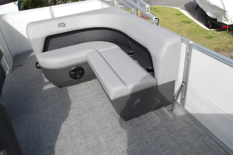 Slide: The Image of 2026 Sun Tracker Party Barge 18 DLX interior with gray seating and cup holders. - 16