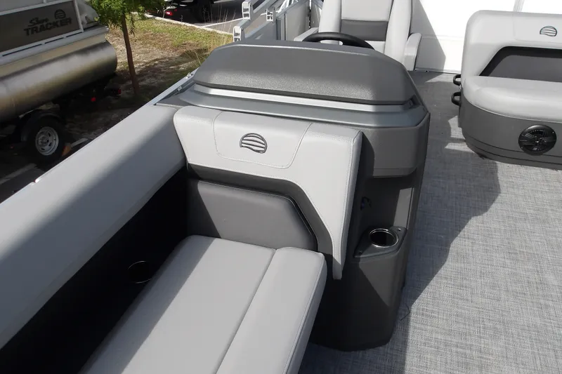 Slide: The Image of 2026 Sun Tracker Party Barge 18 DLX interior with gray seating and cup holders. - 15