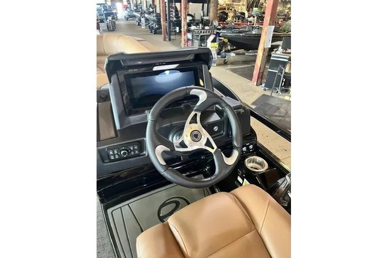 The Image of Steering console of 2026 Regency 230 DL boat with modern controls and display. - 0