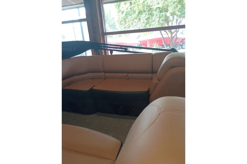 Slide: The Image of Luxurious seating inside a 2026 Regency 230 DL boat, featuring tan upholstery and spacious design. - 3