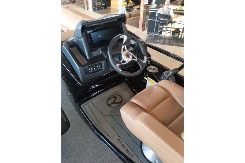 Slide: The Image of 2026 Regency 230 DL boat interior with steering wheel and dashboard controls. - 1