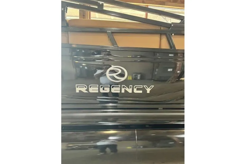 Slide: The Image of 2026 Regency 230 DL boat with sleek black exterior and logo. - 3
