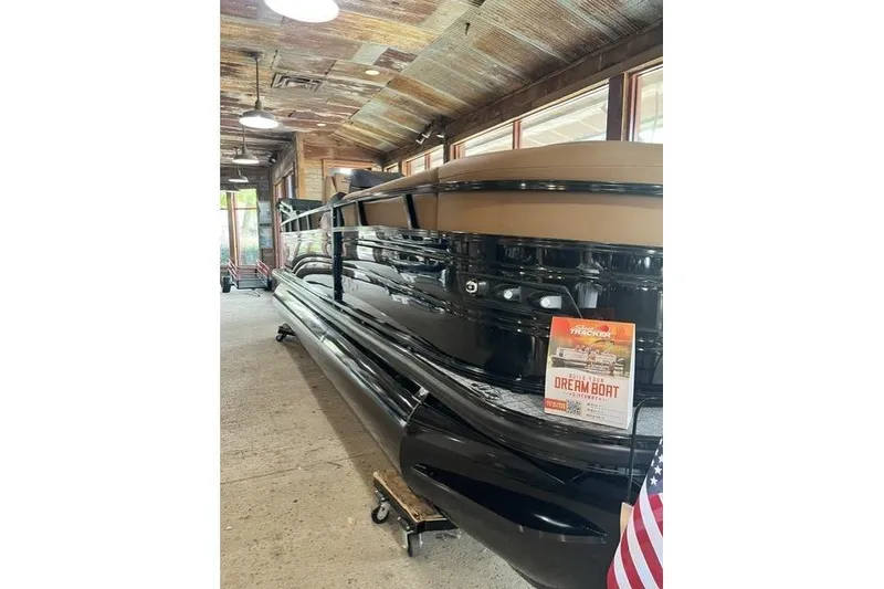 Slide: The Image of 2026 Regency 230 DL boat displayed indoors with promotional sign. - 1