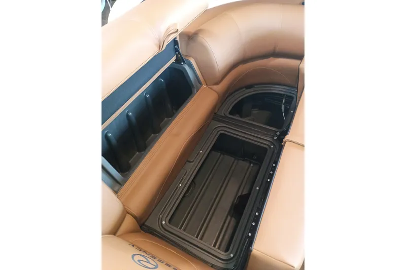 Slide: The Image of 2026 Regency 230 DL boat interior with tan leather seating and storage compartments. - 6