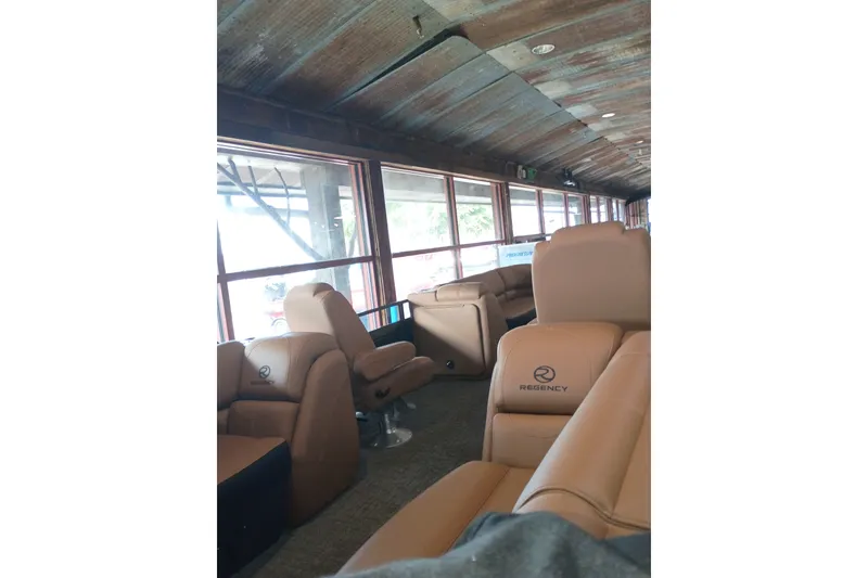 Slide: The Image of Luxurious interior of 2026 Regency 230 DL with plush seating and panoramic windows. - 13