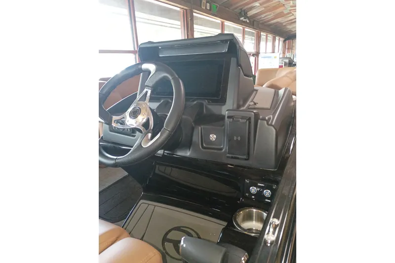 Slide: The Image of Steering console of 2026 Regency 230 DL boat with modern controls and cup holder. - 8