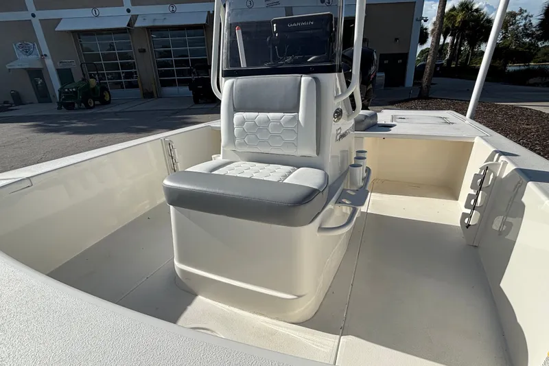 Slide: The Image of 2026 Mako 18 Pro Skiff boat interior with cushioned seating and console. - 10