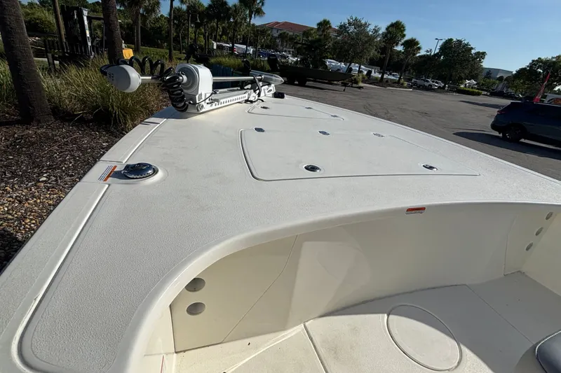 Slide: The Image of 2026 Mako 18 Pro Skiff boat deck with trolling motor in a sunny outdoor setting. - 9