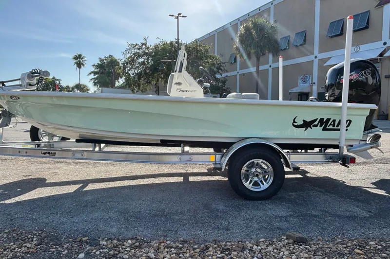 Slide: The Image of 2026 Mako 18 Pro Skiff boat on trailer, parked outdoors, side view. - 3