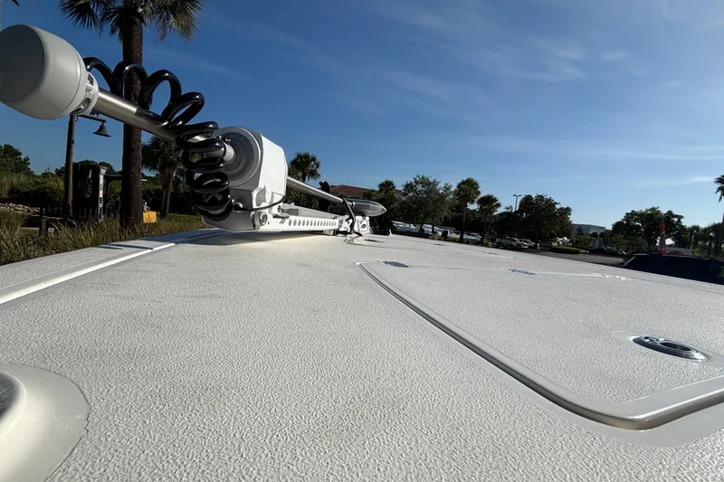 Slide: The Image of 2026 Mako 18 Pro Skiff boat deck with mounted equipment under clear blue sky. - 8