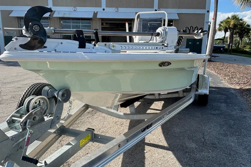 Slide: The Image of 2026 Mako 18 Pro Skiff boat on trailer, parked outdoors. - 4