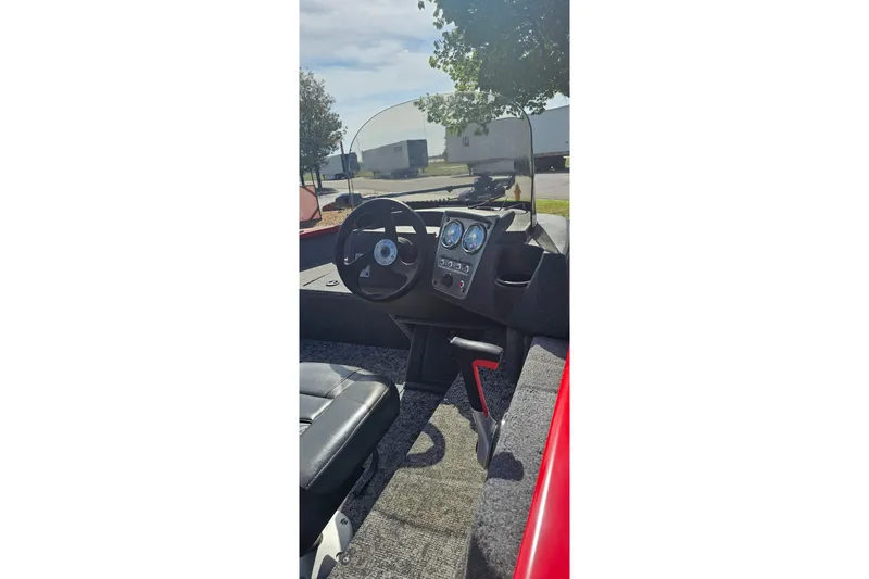 Slide: The Image of 2026 Tracker Pro Guide V-16 SC boat interior with steering wheel and dashboard controls. - 54