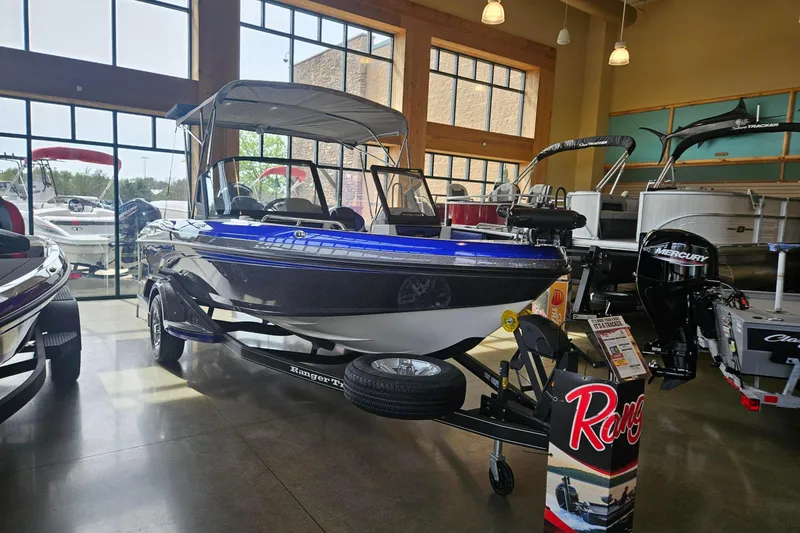 Slide: The Image of 2026 Ranger 1850MS boat displayed in a showroom with large windows. - 99