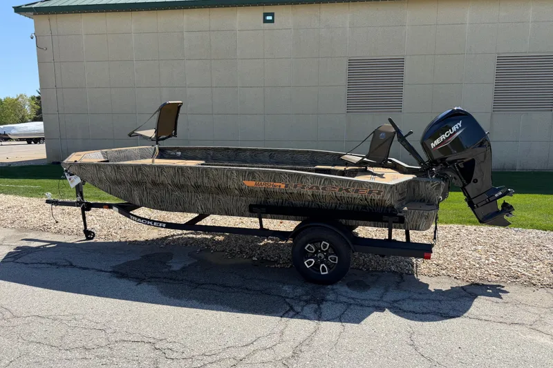 The Image of 2026 Tracker Grizzly 1756 T Marsh boat with Mercury engine on trailer, outdoors. - 0