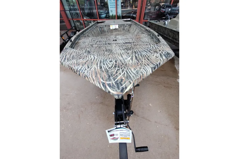 Slide: The Image of 2026 Tracker Grizzly 1648 Utility boat with camouflage design on display. - 5