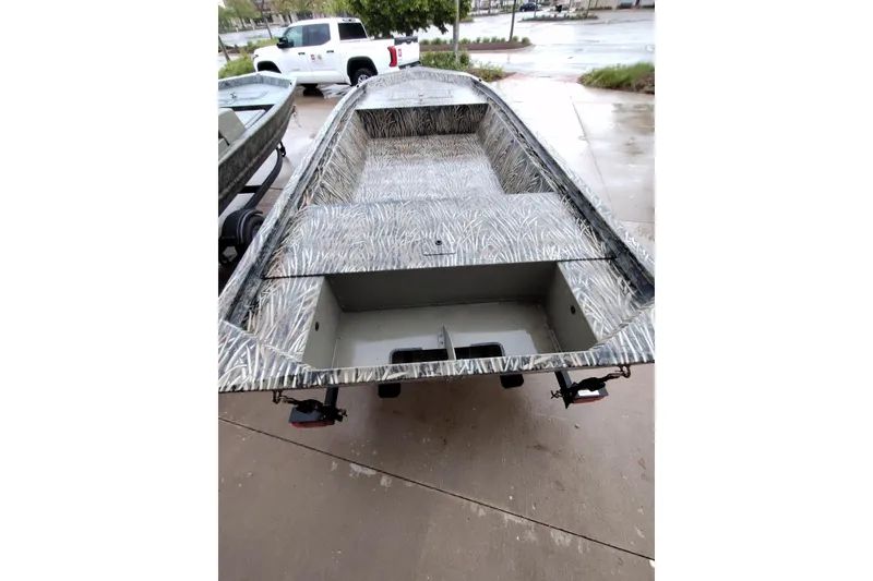 Slide: The Image of 2026 Tracker Grizzly 1648 Utility boat with camouflage design on a trailer. - 6