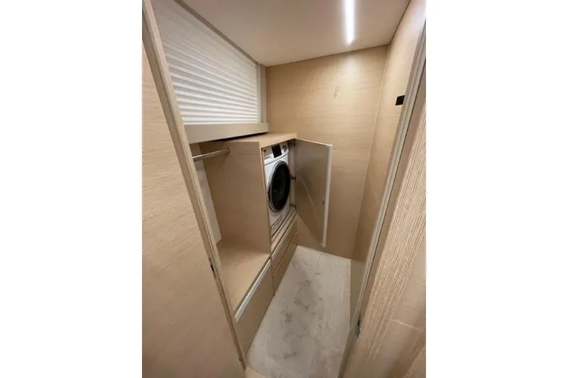 Slide: The Image of Laundry area inside 2022 Greenline 45 Fly yacht, featuring a modern washing machine. - 14