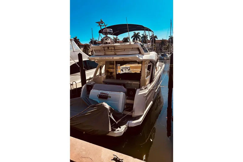 Slide: The Image of 2022 Greenline 45 Fly yacht docked in a sunny marina. - 22