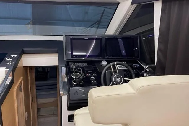 Slide: The Image of Helm of 2022 Greenline 45 Fly yacht with modern navigation equipment and luxurious seating. - 4