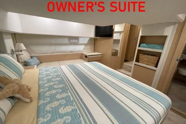 Slide: The Image of Owner's suite in 2022 Greenline 45 Fly yacht, featuring a cozy bed and modern decor. - 5
