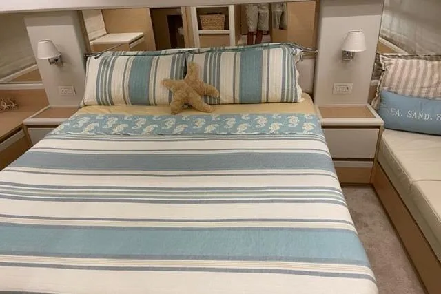 Slide: The Image of Luxurious bedroom interior of 2022 Greenline 45 Fly yacht with striped bedding. - 6