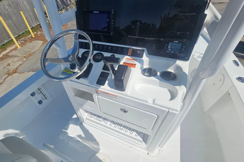 Slide: The Image of 2017 Sea Hunt BX 22 BR boat console with steering wheel and controls. - 10