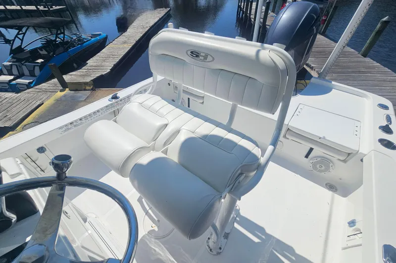 Slide: The Image of 2017 Sea Hunt BX 22 BR boat interior with white seating and steering wheel. - 11