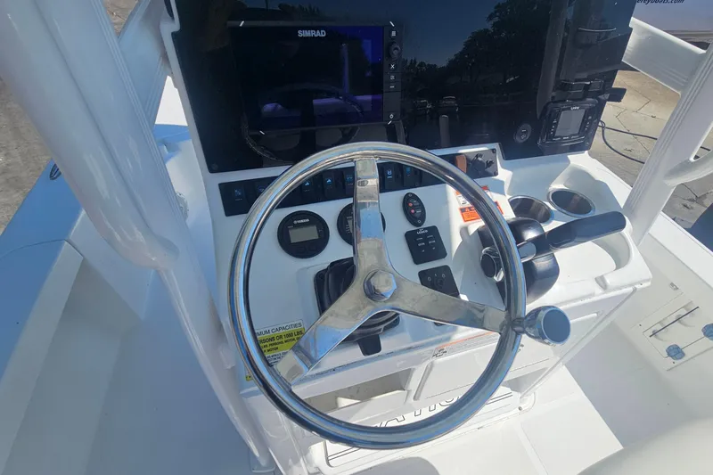 Slide: The Image of 2017 Sea Hunt BX 22 BR boat console with steering wheel and navigation controls. - 12