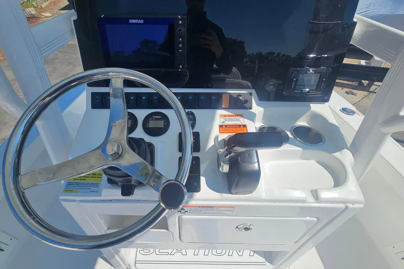 Slide: The Image of 2017 Sea Hunt BX 22 BR boat console with steering wheel and controls. - 13