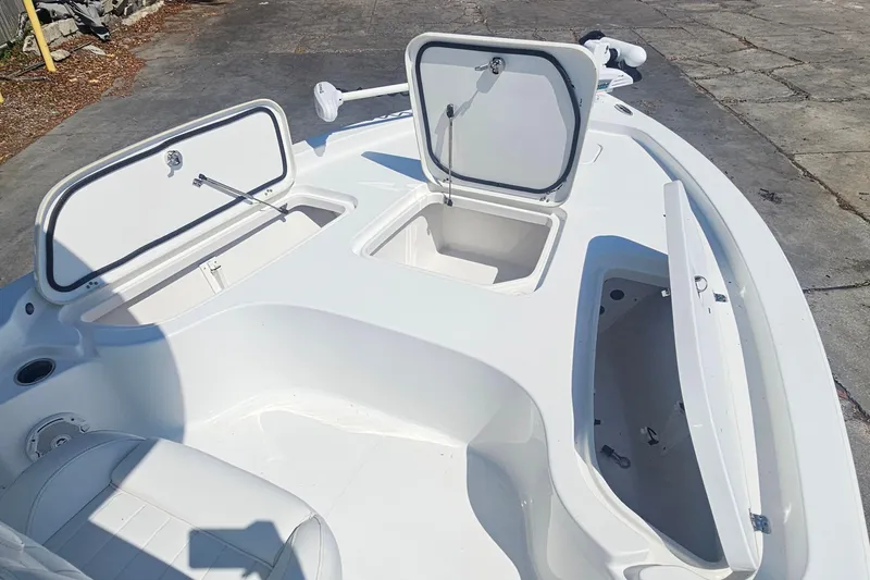 Slide: The Image of 2017 Sea Hunt BX 22 BR boat with open storage compartments on deck. - 16