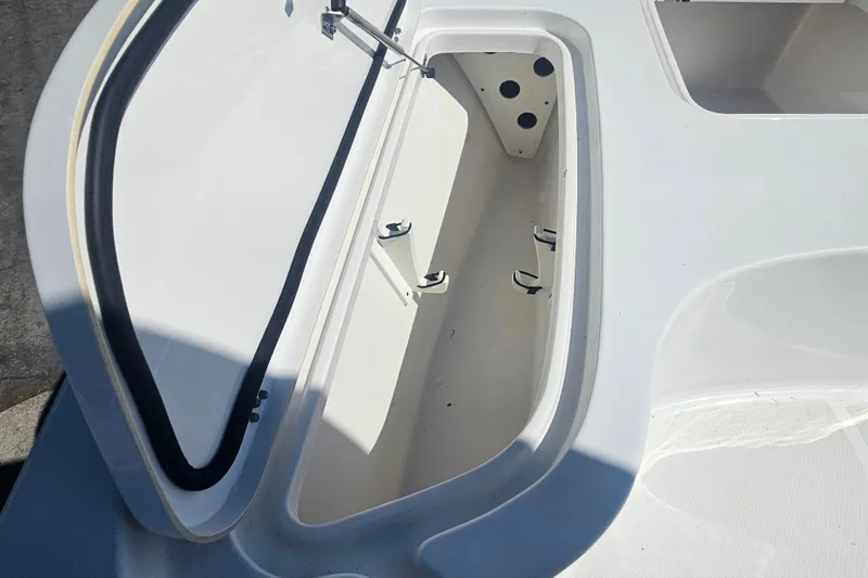 Slide: The Image of Open storage compartment on a 2017 Sea Hunt BX 22 BR boat. - 17