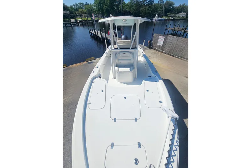 Slide: The Image of 2017 Sea Hunt BX 22 BR boat docked by a calm waterfront. - 19