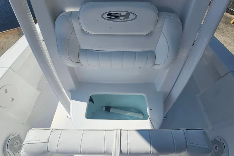 Slide: The Image of 2017 Sea Hunt BX 22 BR boat interior with cushioned seating and storage compartment. - 20