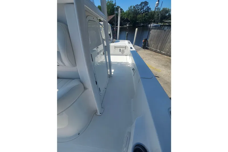 Slide: The Image of 2017 Sea Hunt BX 22 BR boat interior, docked by a serene waterfront. - 21